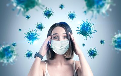 Young woman in a face mask expressing concern surrounded by virus illustrations, highlighting the impact of COVID-19 on health and eye care.